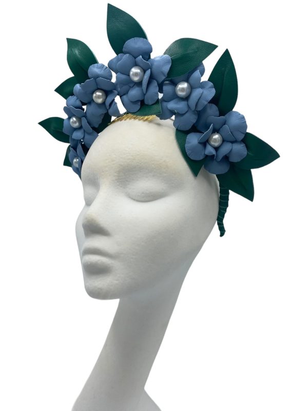 Large blue leather flower crown with green leather leaf detail.